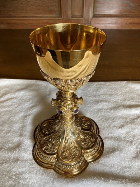 The chalice – The gold vessel in the form of a formal cup which holds the wine which then becomes the Blood of Christ upon the words of consecration.
