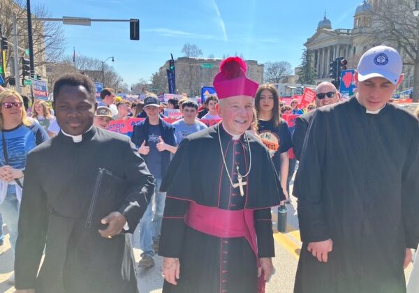 Bishop Thomas John Paprocki, center, Father Peter Chineke, left, Father Dominic Vahling, right