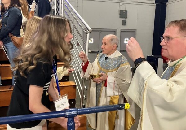 Bishops Paprocki and Tylka distribute Communion