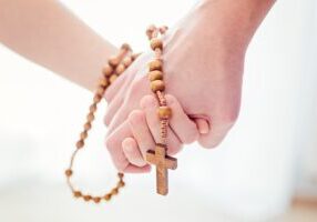 Mother and son praying together. Holding rosary in hand. More from this series in my portfolioMother and child praying together. Holding rosary in hand. More from this series in my portfolio