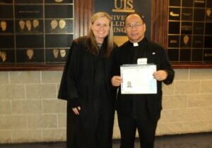 Judge Colleen Lawless, who concundted the Naturalization Cermeny, with Father Manny Cuizon, who became a U.S. citizen on Aug. 30. Fr. Manny is pastor of St. Joseph Parish in Springfield

Submitted photo