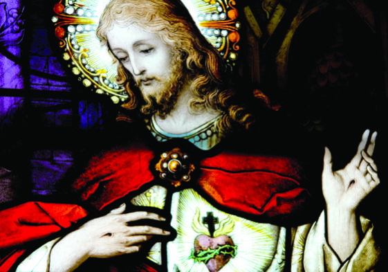 This is a close up photo of a stained glass window depicting Jesus Christ.